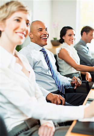 Business people smiling in meeting Stock Photo - Premium Royalty-Free, Code: 6113-07242747