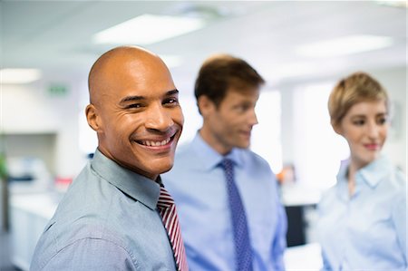 Businessman smiling in office Stock Photo - Premium Royalty-Free, Code: 6113-07242755