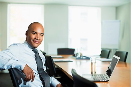 simsearch:649-07238396,k - Businessman smiling at conference table Stock Photo - Premium Royalty-Free, Code: 6113-07242764