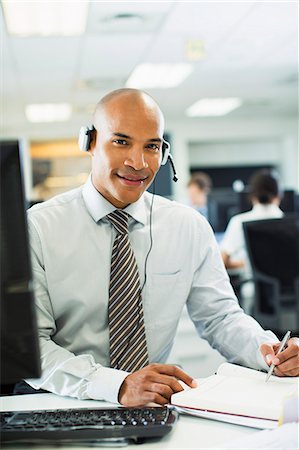 sale - Businessman wearing headset in office Stock Photo - Premium Royalty-Free, Code: 6113-07242739