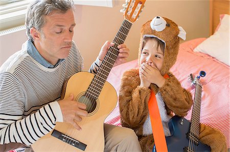 father holding his son - Father and son playing guitar together Stock Photo - Premium Royalty-Free, Code: 6113-07242842