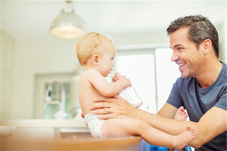 simsearch:6113-07543218,k - Father feeding baby in kitchen Stock Photo - Premium Royalty-Free, Code: 6113-07242875