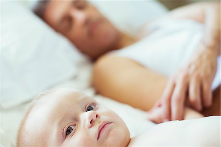 simsearch:6113-07543205,k - Father and baby laying on bed Stock Photo - Premium Royalty-Free, Code: 6113-07242892