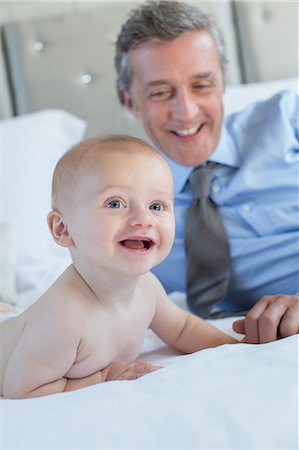 simsearch:6113-07242957,k - Father and baby relaxing on bed Stock Photo - Premium Royalty-Free, Code: 6113-07242950