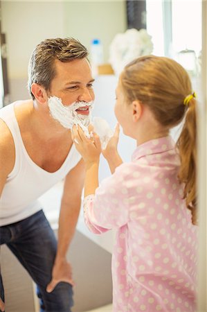 simsearch:6113-07242957,k - Girl rubbing shaving cream on father's face Stock Photo - Premium Royalty-Free, Code: 6113-07242960