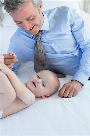 simsearch:6113-07242957,k - Father playing with baby on bed Stock Photo - Premium Royalty-Free, Code: 6113-07242989