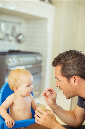 simsearch:6113-07543205,k - Father feeding baby in high chair Stock Photo - Premium Royalty-Free, Code: 6113-07242904