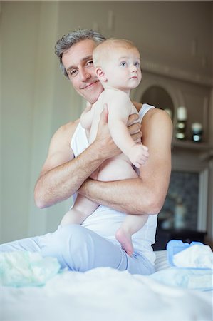 Father holding baby on bed Stock Photo - Premium Royalty-Free, Code: 6113-07242916