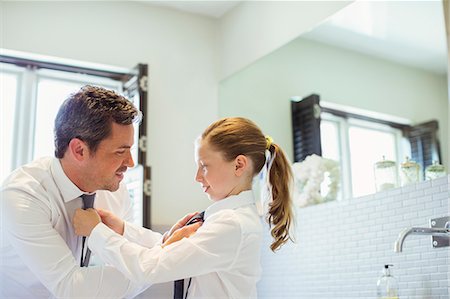 simsearch:6113-07242957,k - Father and daughter tying each other's ties Stock Photo - Premium Royalty-Free, Code: 6113-07242930