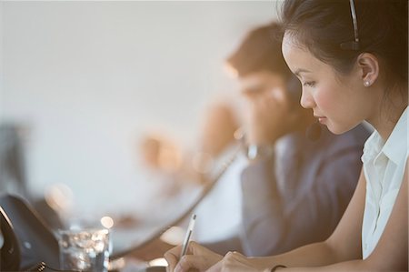 person on office desk phone - Business people working in office Stock Photo - Premium Royalty-Free, Code: 6113-07243043