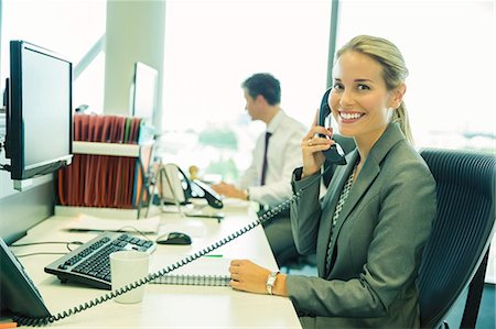 phone happy sitting - Businesswoman talking on telephone in office Stock Photo - Premium Royalty-Free, Code: 6113-07243065