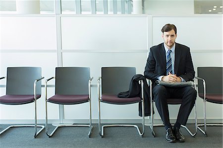 recruiting - Businessman sitting in waiting area Stock Photo - Premium Royalty-Free, Code: 6113-07243098
