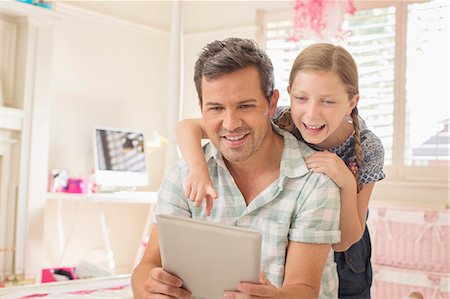 Father and daughter using digital tablet Stock Photo - Premium Royalty-Free, Code: 6113-07243010