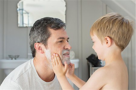 dad shaved boy pictures - Boy rubbing shaving cream on father's face Stock Photo - Premium Royalty-Free, Code: 6113-07243019