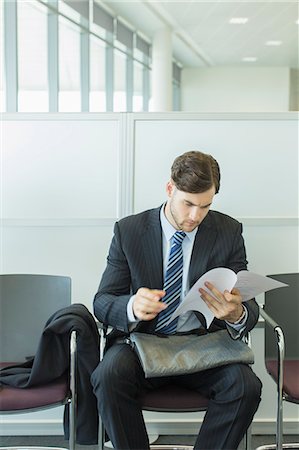 simsearch:6113-07243220,k - Businessman looking at resume in waiting area Stock Photo - Premium Royalty-Free, Code: 6113-07243102