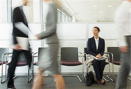 simsearch:6113-07243220,k - Businesswoman sitting in busy waiting area Stock Photo - Premium Royalty-Free, Code: 6113-07243112