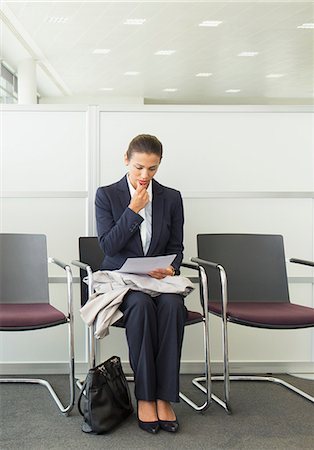 simsearch:6113-07243220,k - Businesswoman reading in waiting area Stock Photo - Premium Royalty-Free, Code: 6113-07243139
