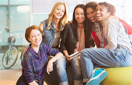 simsearch:6113-07542497,k - Women smiling together on beanbag Stock Photo - Premium Royalty-Free, Code: 6113-07243270
