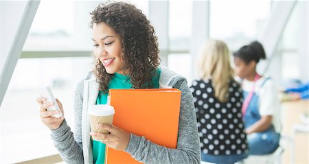 student texting on cell phone - University student using cell phone Stock Photo - Premium Royalty-Free, Code: 6113-07243311