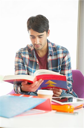 student (male) - University student reading textbook in lounge Stock Photo - Premium Royalty-Free, Code: 6113-07243403