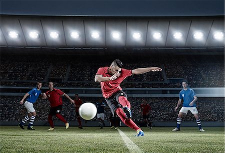 soccer field - Soccer player kicking ball on field Foto de stock - Sin royalties Premium, Código: 6113-07310554