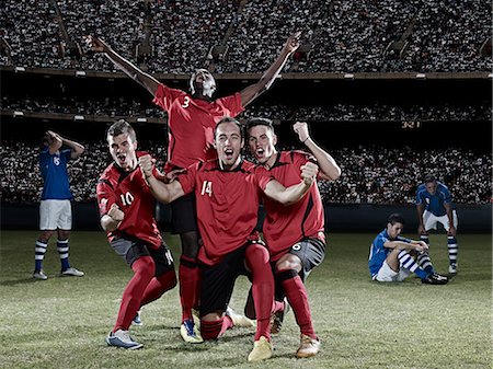 soccer stadium at nights - Soccer players cheering on field Stock Photo - Premium Royalty-Free, Code: 6113-07310573