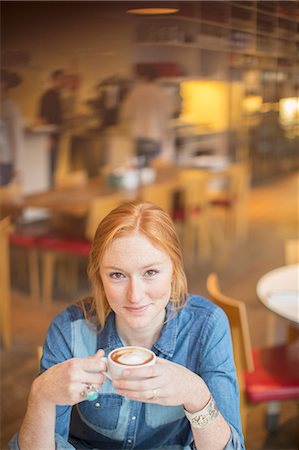Woman drinking cup of coffee in cafe Stock Photo - Premium Royalty-Free, Code: 6113-07542468