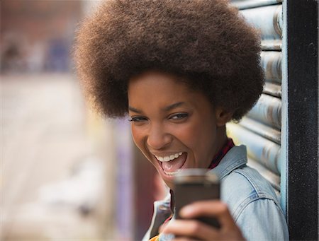 excited young woman - Woman taking self-portrait with cell phone outdoors Stock Photo - Premium Royalty-Free, Code: 6113-07542404