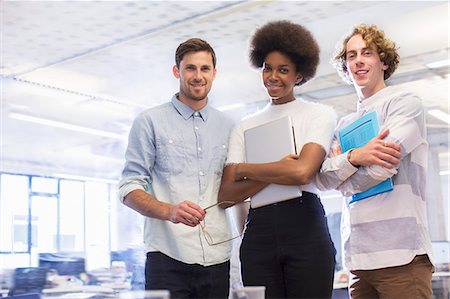 Business people smiling in office Stock Photo - Premium Royalty-Free, Code: 6113-07542433