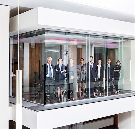 Business people standing at window of modern conference room Stock Photo - Premium Royalty-Free, Code: 6113-07542617