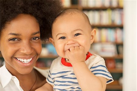 simsearch:6113-07543258,k - Mother holding baby boy in living room Photographie de stock - Premium Libres de Droits, Code: 6113-07542856