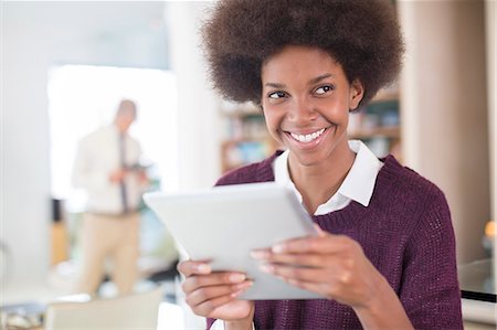 Businesswoman using tablet in living room Stock Photo - Premium Royalty-Free, Code: 6113-07542874