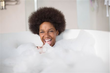 Woman laughing in bubble bath Stock Photo - Premium Royalty-Free, Code: 6113-07542882