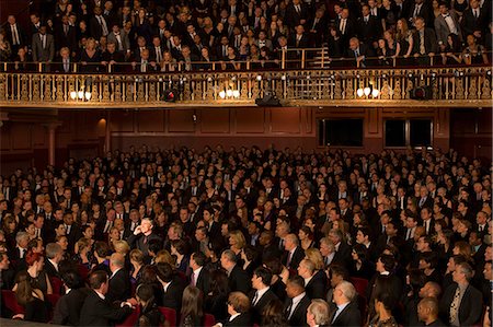 simsearch:6113-07542941,k - Spotlight on audience member using cell phone in theater Stock Photo - Premium Royalty-Free, Code: 6113-07542938