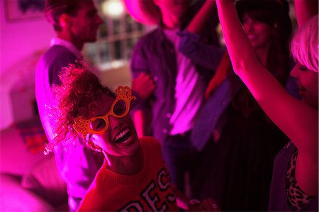 excited young woman - Friends dancing together at party Stock Photo - Premium Royalty-Free, Code: 6113-07543083