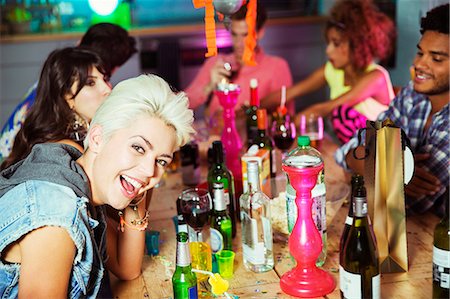 simsearch:6113-07543030,k - Woman smiling at party Stock Photo - Premium Royalty-Free, Code: 6113-07543023