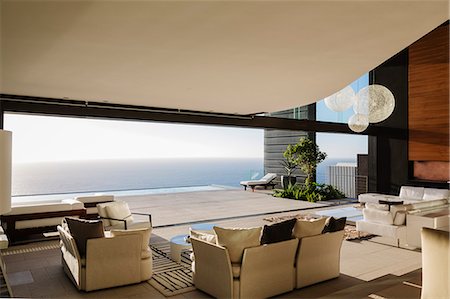 door window - Modern living room overlooking ocean Stock Photo - Premium Royalty-Free, Code: 6113-07543353