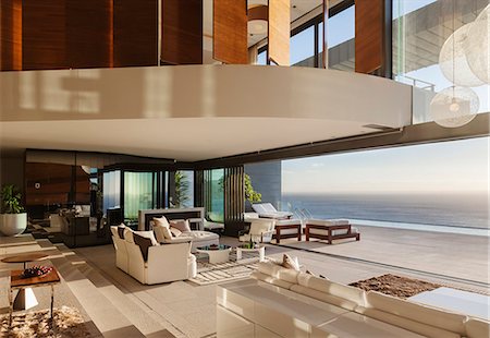 simsearch:6113-07542742,k - Living room in modern house overlooking ocean Stock Photo - Premium Royalty-Free, Code: 6113-07543377