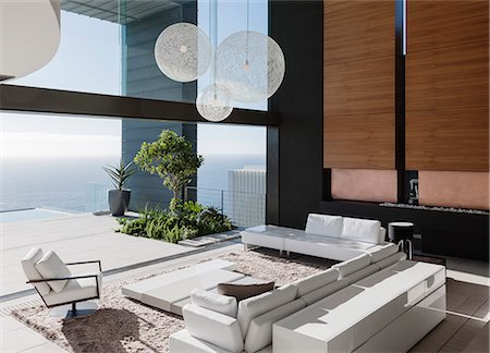 simsearch:6113-07542742,k - Modern living room overlooking ocean Stock Photo - Premium Royalty-Free, Code: 6113-07543302