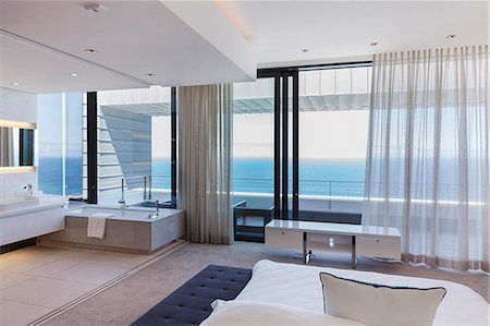 simsearch:6113-07542764,k - Modern bedroom overlooking ocean Stock Photo - Premium Royalty-Free, Code: 6113-07543311