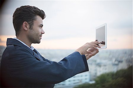 paris sunrise - Businessman using digital tablet outdoors Stock Photo - Premium Royalty-Free, Code: 6113-07543446