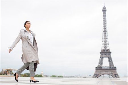 Businesswoman walking past Eiffel Tower, Paris, France Stock Photo - Premium Royalty-Free, Code: 6113-07543469