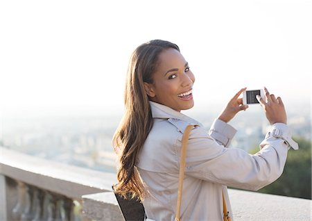 rail travel - Businesswoman taking pictures with cell phone outdoors Stock Photo - Premium Royalty-Free, Code: 6113-07543483