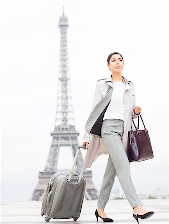 Businesswoman walking past Eiffel Tower, Paris, France Stock Photo - Premium Royalty-Free, Code: 6113-07543427