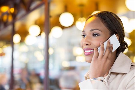 Businesswoman talking on cell phone at sidewalk cafe Stock Photo - Premium Royalty-Free, Code: 6113-07543426