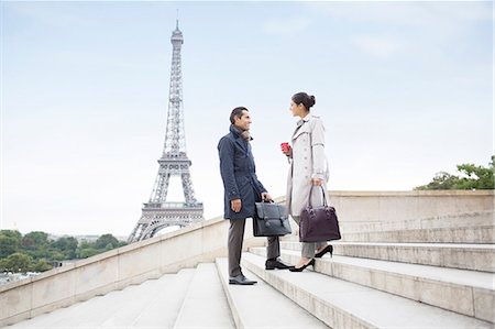 Business people talking on steps near Eiffel Tower, Paris, France Stock Photo - Premium Royalty-Free, Code: 6113-07543433