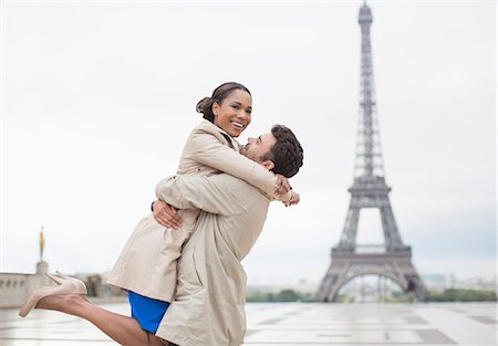 romance in paris - Couple hugging by Eiffel Tower, Paris, France Stock Photo - Premium Royalty-Free, Code: 6113-07543546