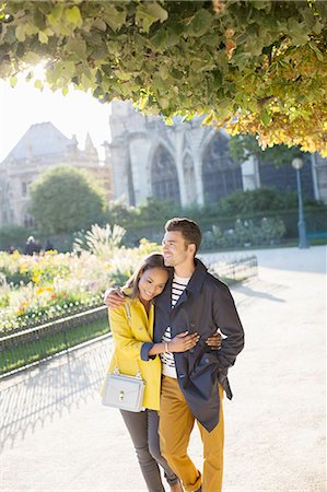 simsearch:6113-07543676,k - Couple walking together in urban park Stock Photo - Premium Royalty-Free, Code: 6113-07543551