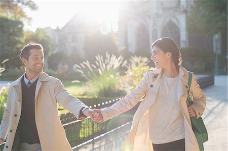 simsearch:6113-07543676,k - Couple holding hands in urban park Stock Photo - Premium Royalty-Free, Code: 6113-07543554