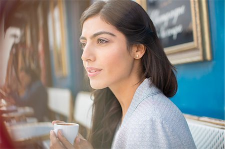 Woman drinking espresso at sidewalk cafe Stock Photo - Premium Royalty-Free, Code: 6113-07543564